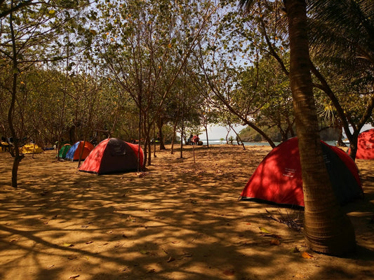 photo of red and gray camping tent near at seashore