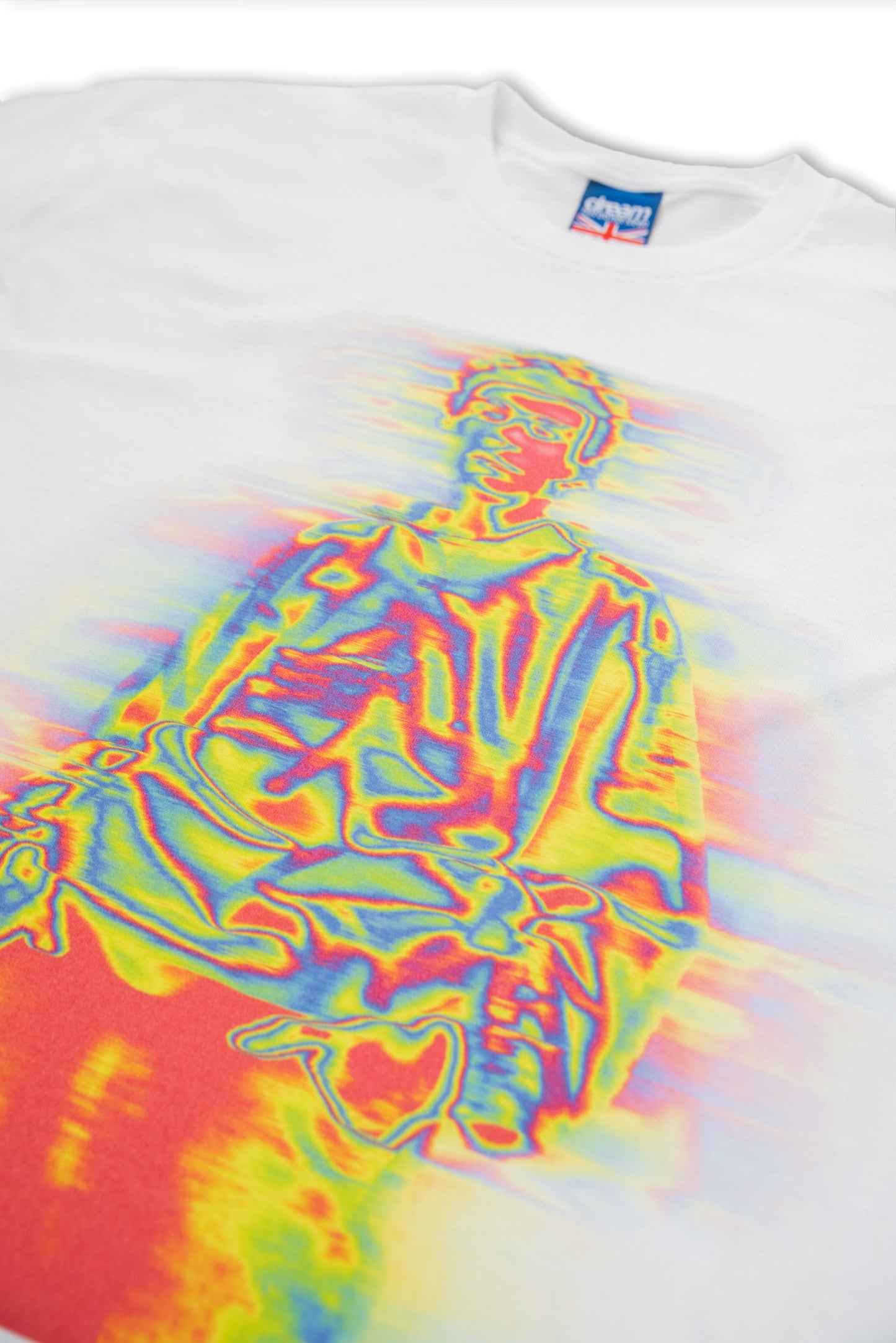 Angled view of white T-shirt with vibrant multicolor print of a seated figure. High-quality DTG print on soft cotton, unisex short sleeve design.