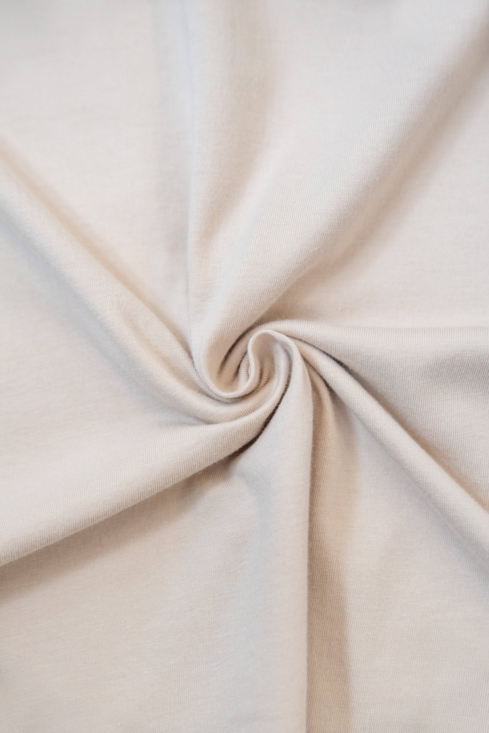 Fabric detail of sand short sleeved t-shirt, showing soft cotton texture ideal for comfort and everyday wear in apparel & accessories.