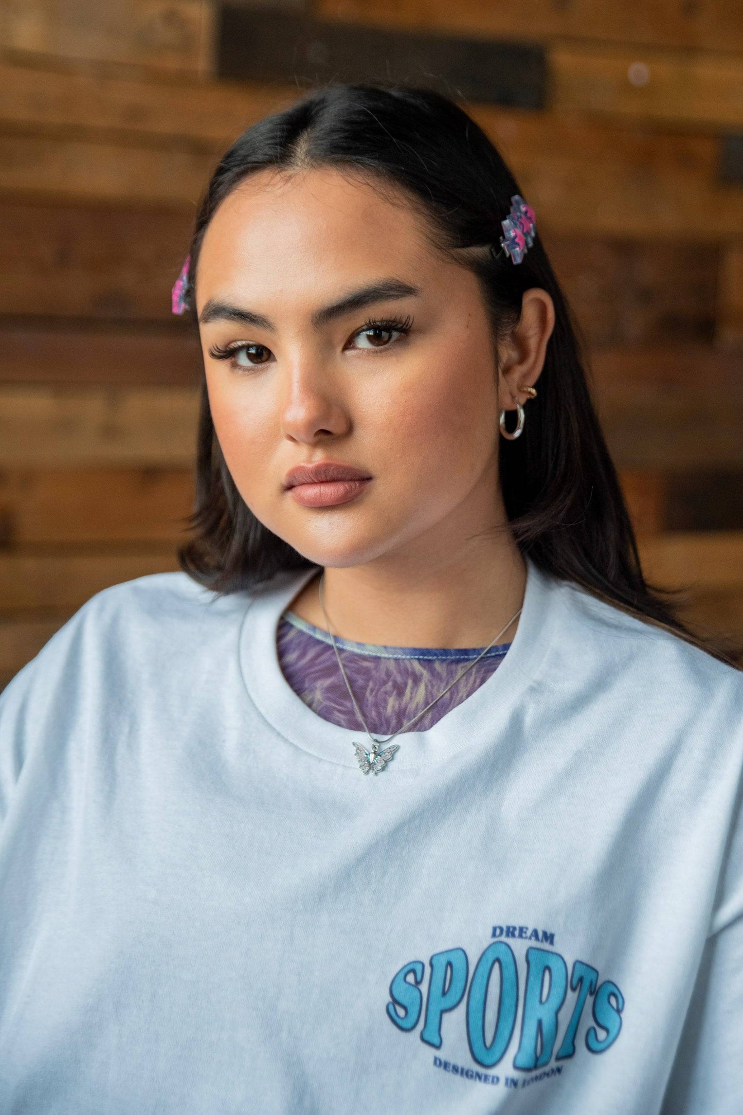 Close-up of unisex white t-shirt featuring Dream Sports logo on chest, highlighting soft cotton texture and woven label detail.