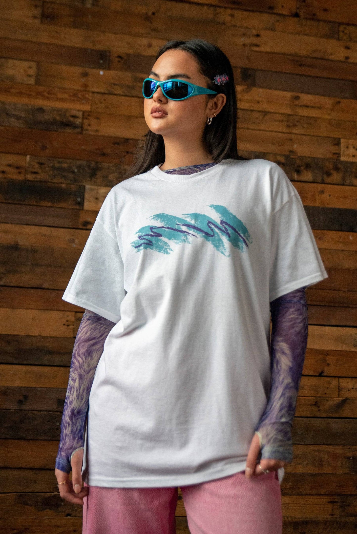 Jazz Cup White T-shirt - Unisex Cotton Tee with bold teal and purple graphic print on chest. Styled with layered sleeves and blue sunglasses.