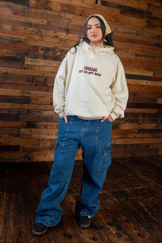 Hoodie with cursive logo - unisex vanilla print in relaxed fit cotton, paired with wide-leg cargo jeans for a streetwear Y2K look.