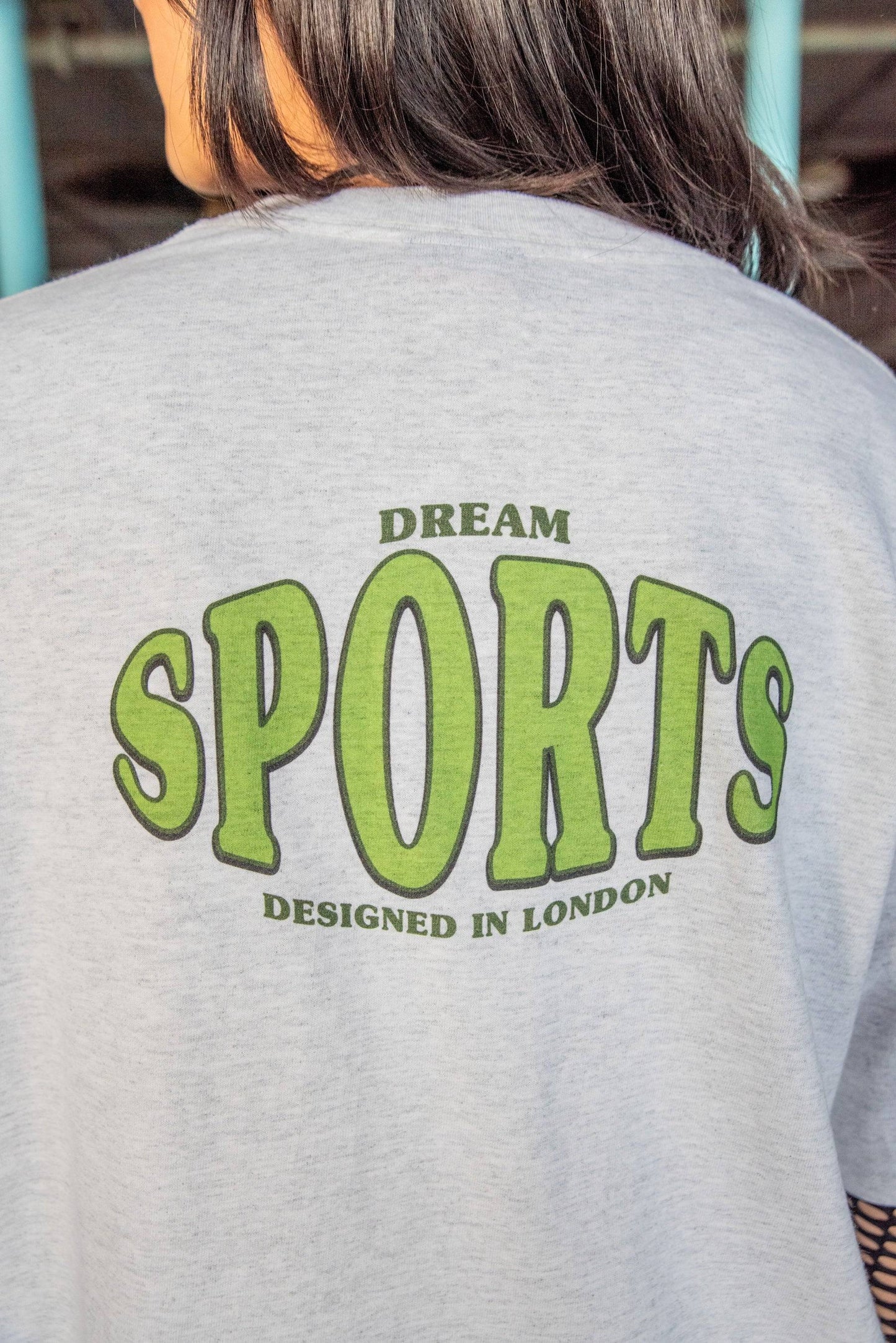 Back view of Heather Grey T-shirt - Dream Sports Print showing large green graphic text. Soft cotton fabric with relaxed silhouette.
