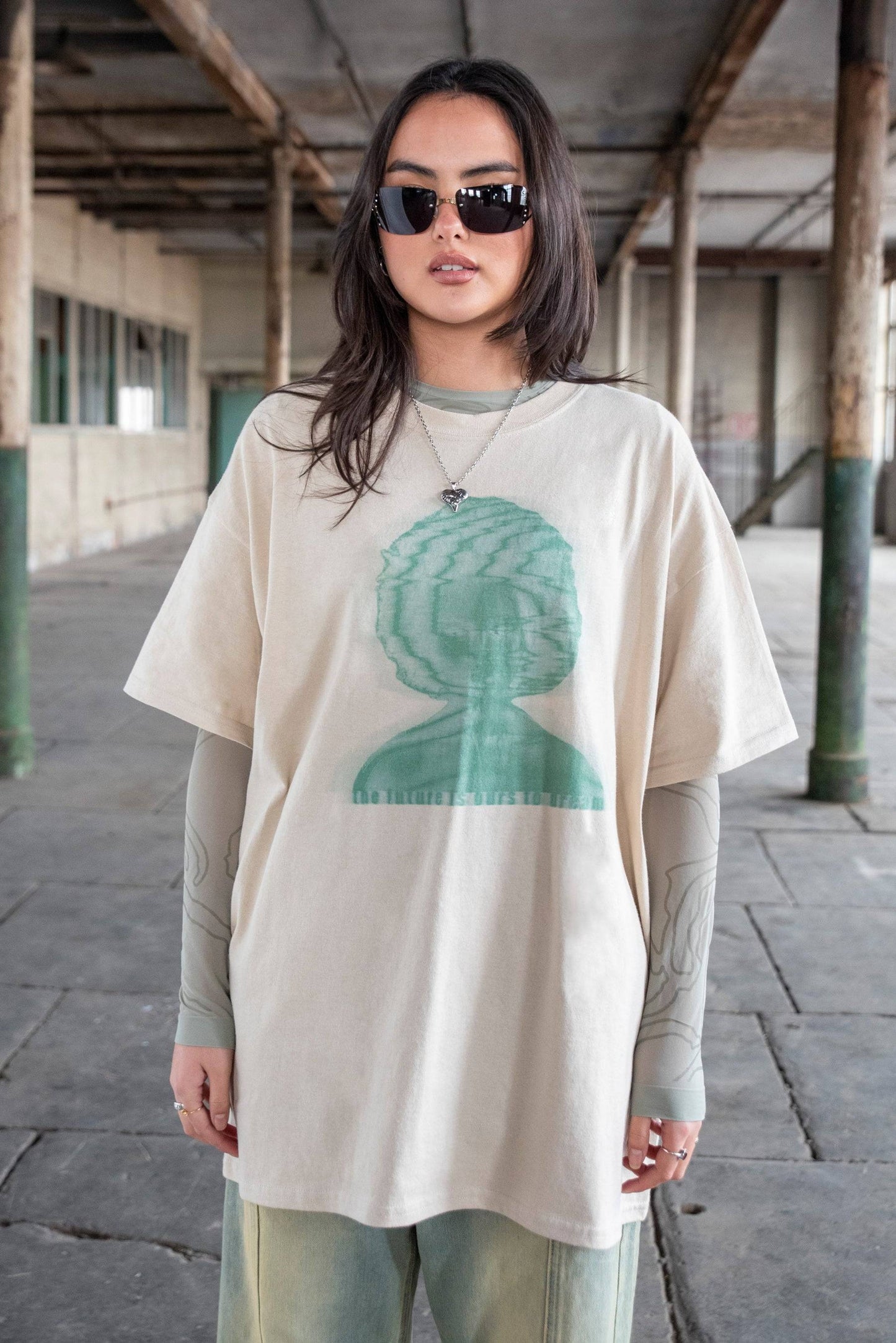 Short Sleeved T-Shirt - Unisex Graphic Tee in sand with green abstract face print and 'The Future Is Ours To Dream' text, made from soft cotton.