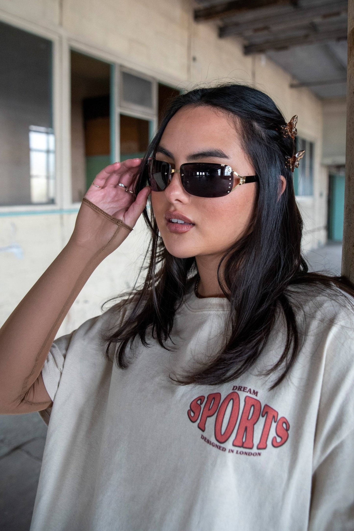 Close-up of model in Dream Sports T-Shirt - Designed in London featuring front chest logo. 100% cotton short sleeve tee.