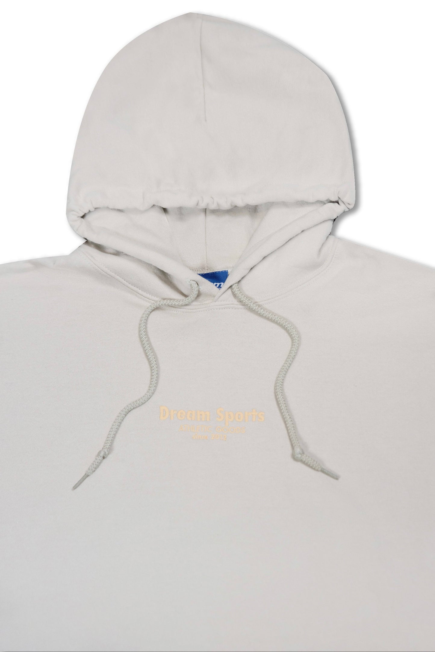 Close-up of the sand hoodie’s hood and chest area, highlighting the tonal Dream Sports logo embroidery and thick drawstrings.