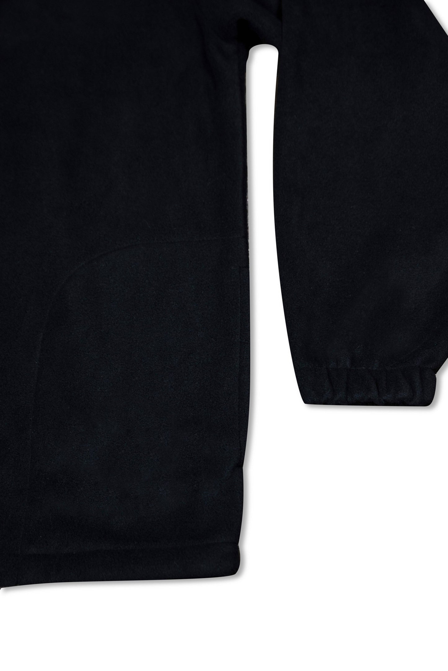 Sleeve and hem detail of black 1/4 zip fleece with elastic cuffs, highlighting durable construction and relaxed fit for everyday wear.