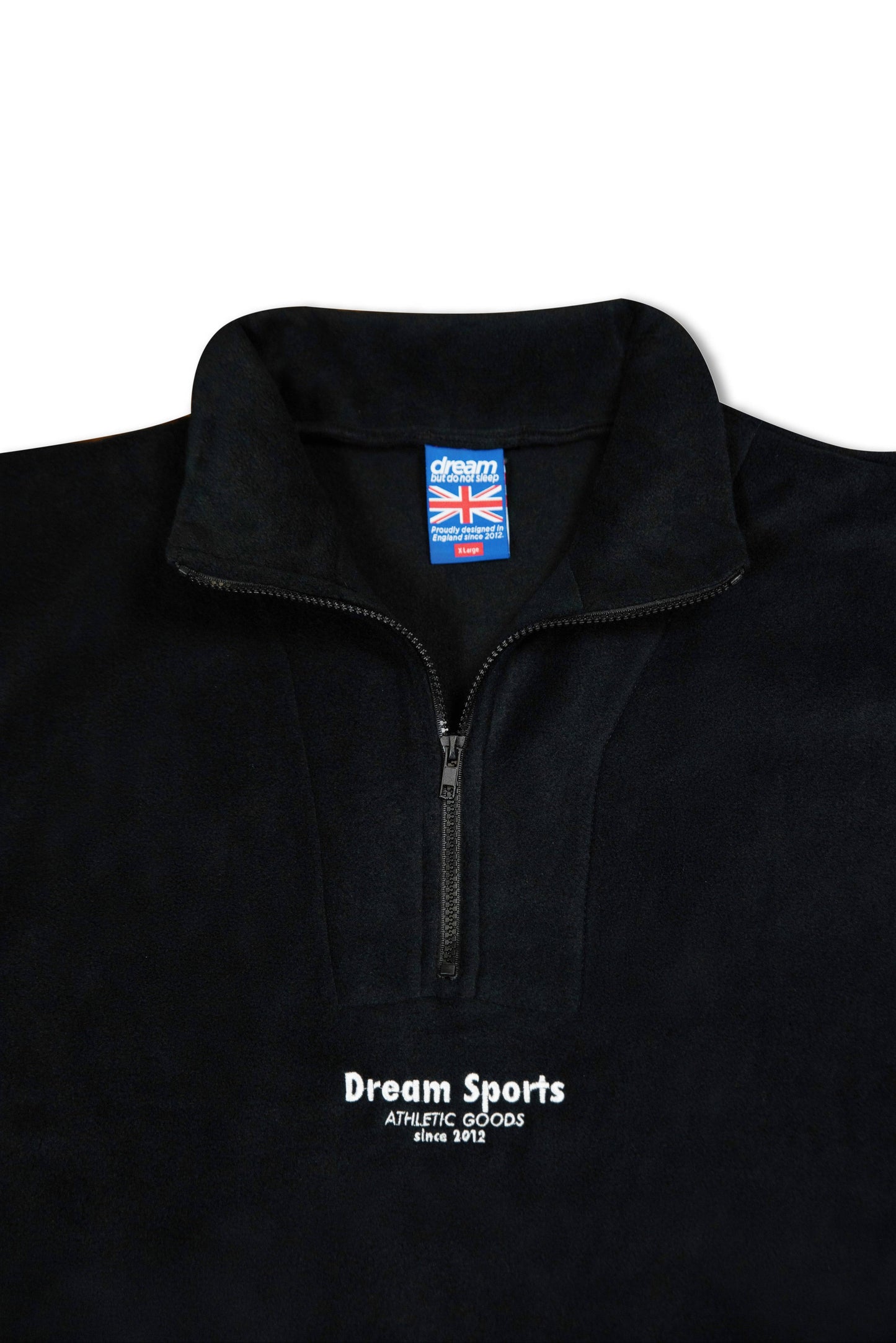 Interior label and zipper detail of black 1/4 zip fleece, showcasing UK-made branding and soft fleece lining for comfort and quality.