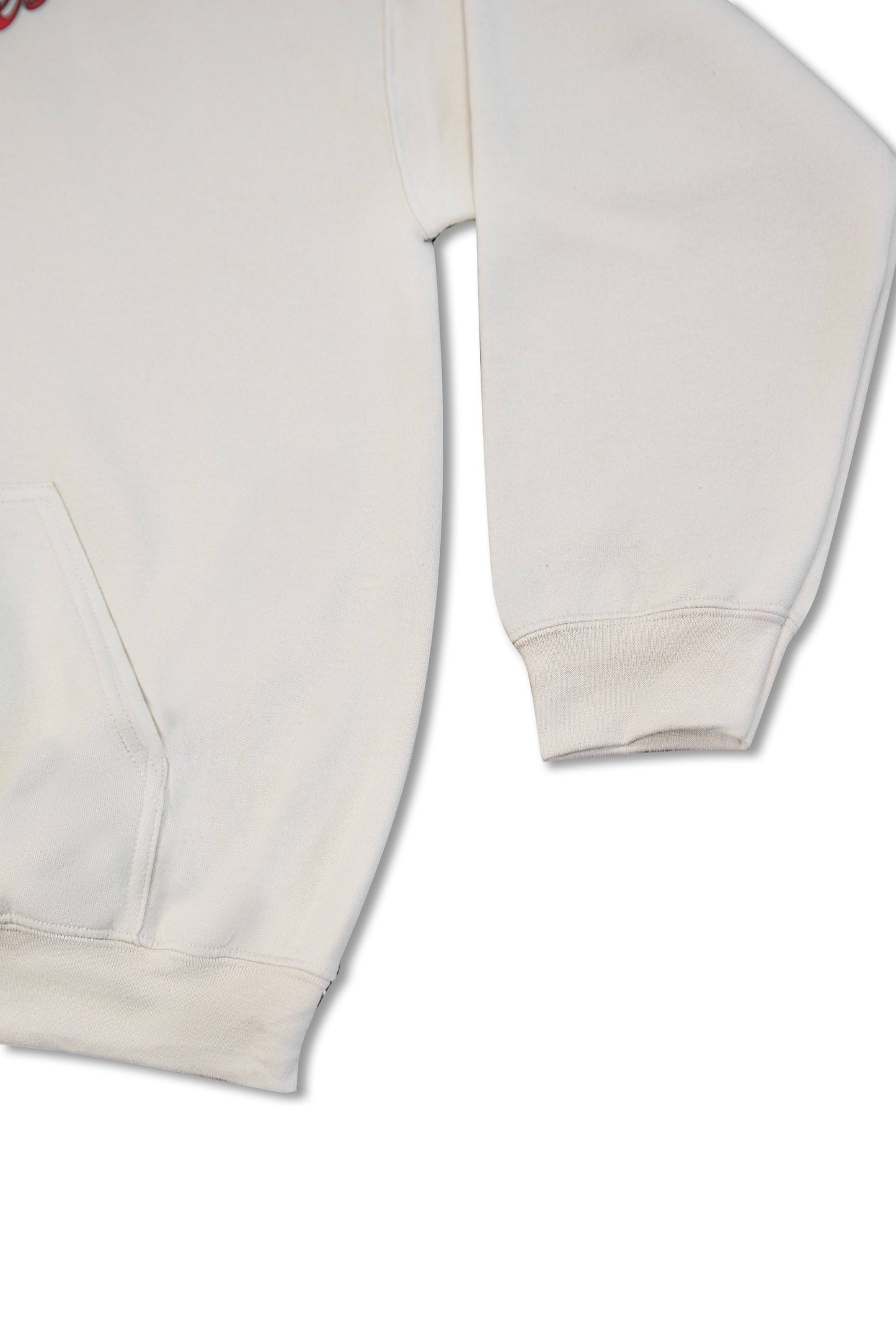 Detail of sleeve and pocket on sand hoodie, showcasing heavyweight cotton texture and relaxed fit for casual wear.
