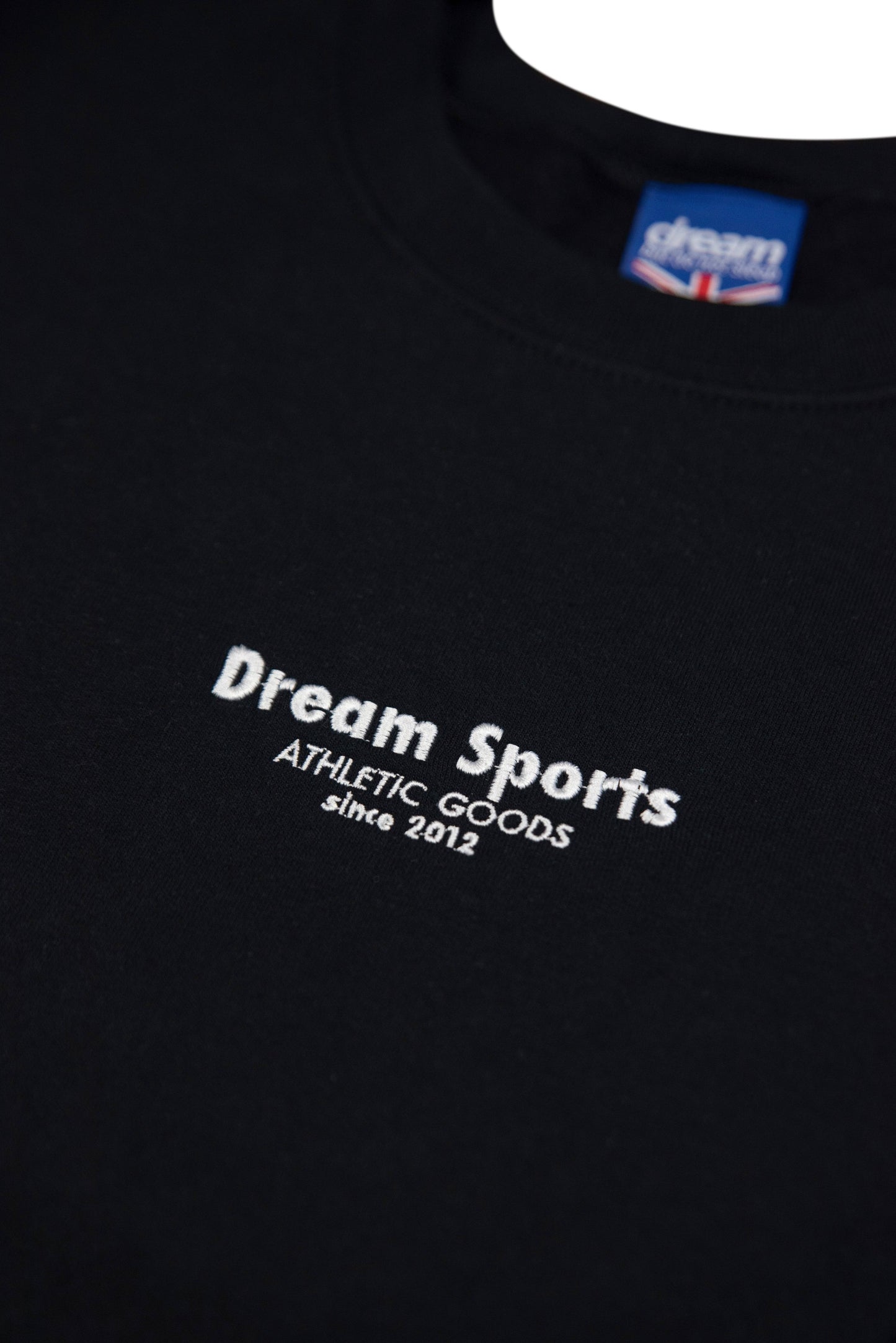 Detailed view of Dream Sports logo embroidery on black sweatshirt, showcasing high-quality threadwork and soft cotton texture.