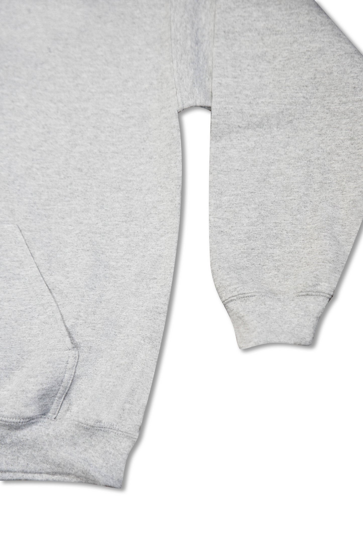 Sleeve and side seam detail of unisex grey hoodie, highlighting ribbed cuffs and soft cotton texture.