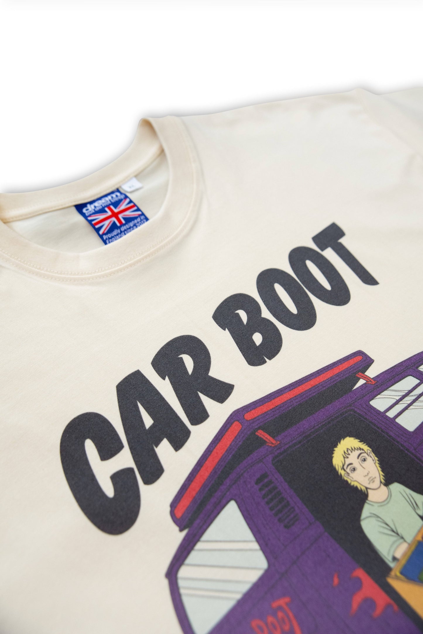 Zoomed-in neckline of Cream T-Shirt - Car Boot Print showing bold 'CAR BOOT' text and part of the illustrated van graphic, UK-made label visible.
