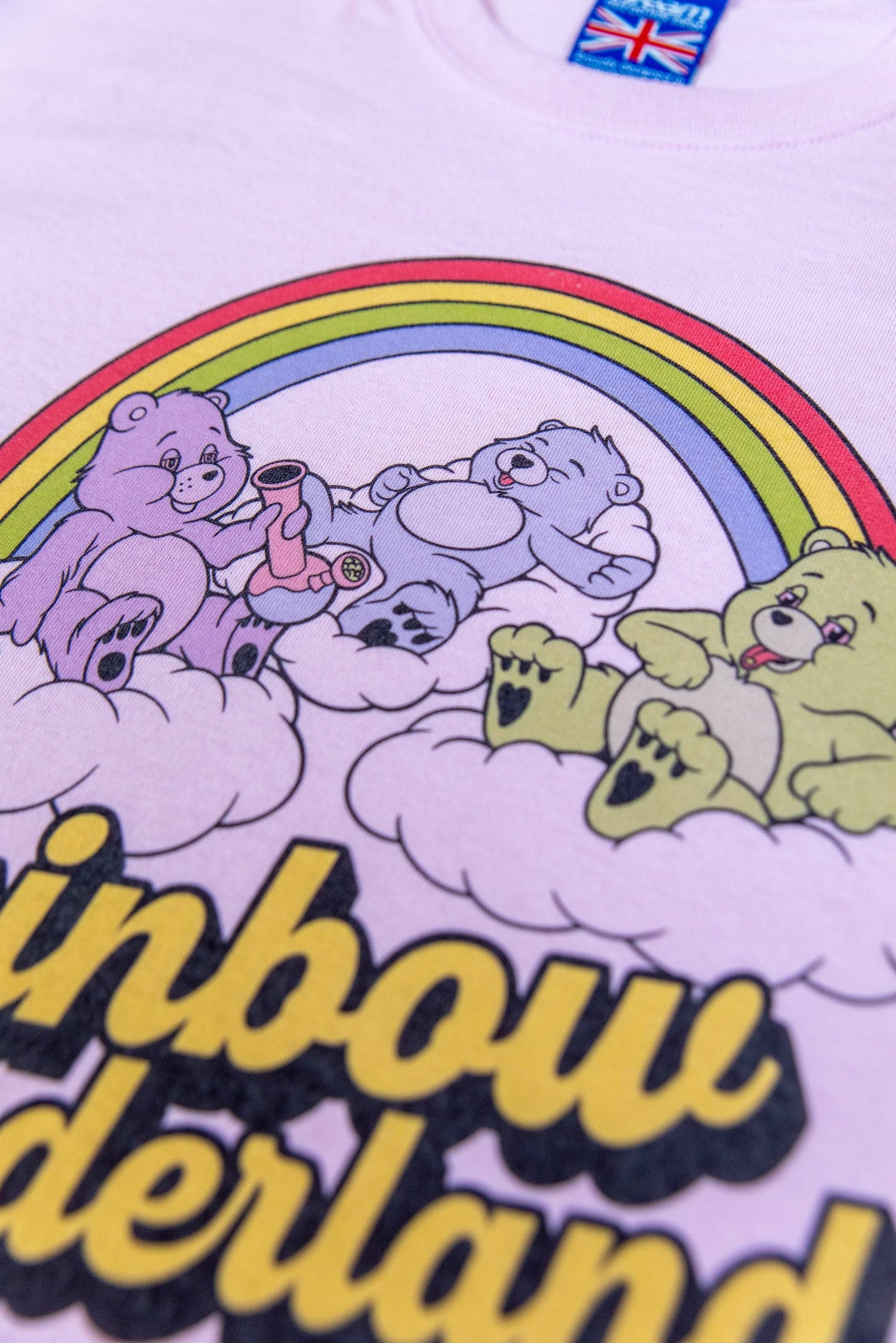 Zoomed-in image of soft cotton pink t-shirt with colorful rainbow and bear design, showcasing premium DTG print and stitching quality.