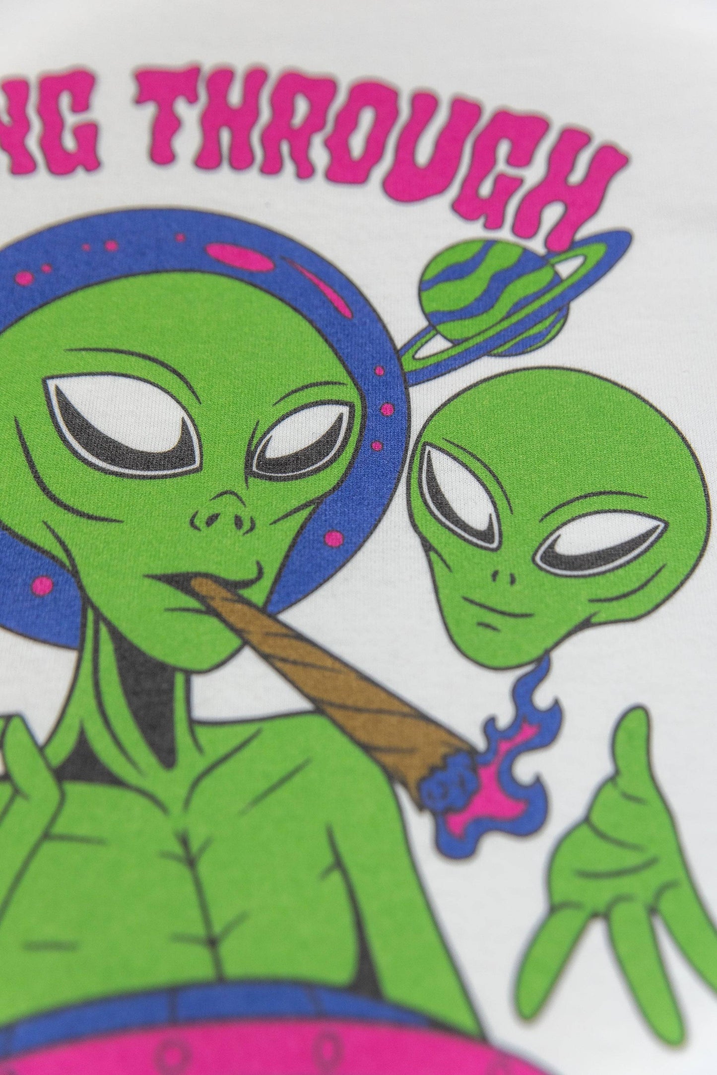 Zoomed-in view of alien smoking detail on White Graphic T-Shirt - Short Sleeved with bold print and vibrant green and purple tones.