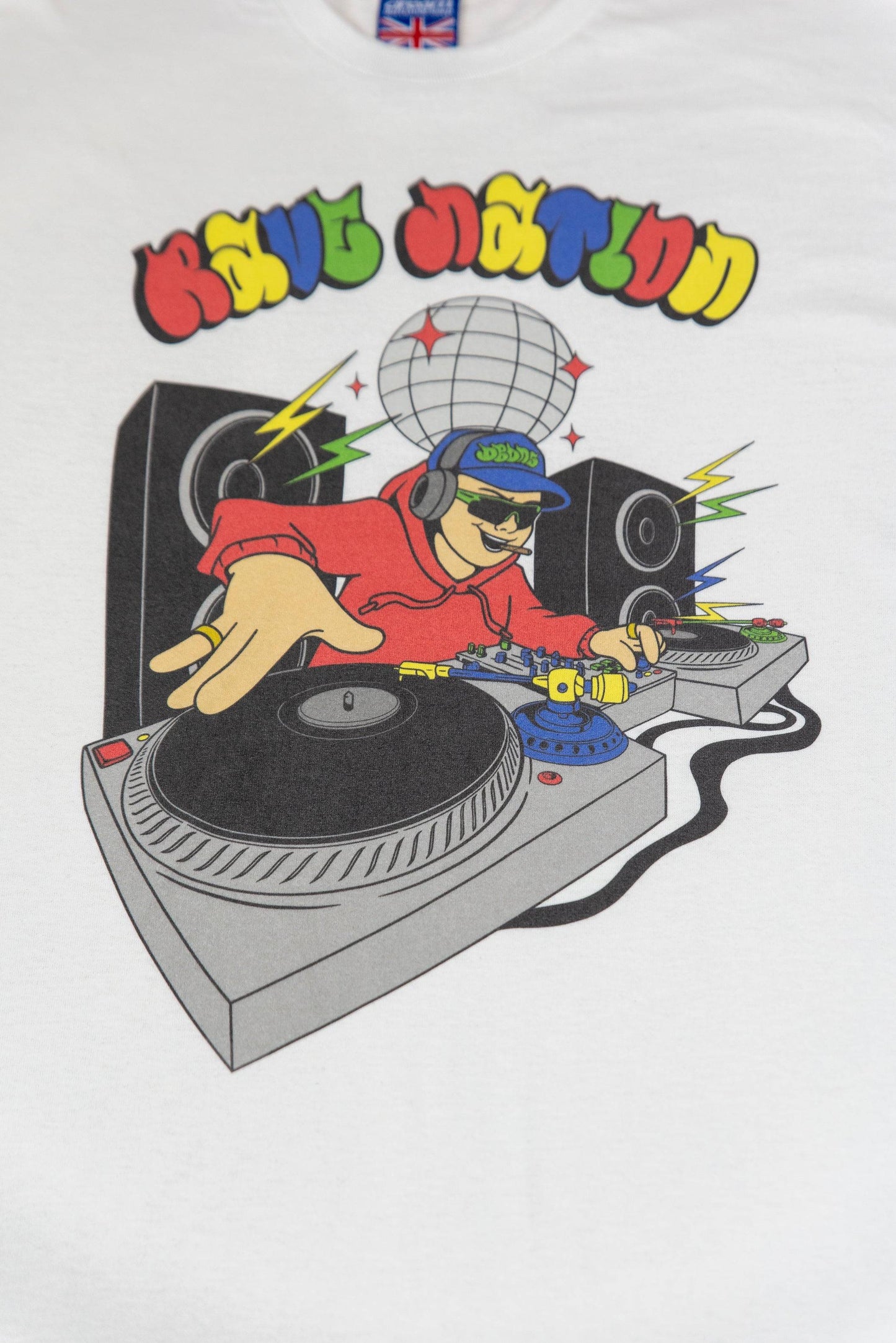 Close-up of Rave Nation DJ print on white T-shirt showing vibrant cartoon DJ, speakers, and disco ball. Durable ink on soft cotton fabric.