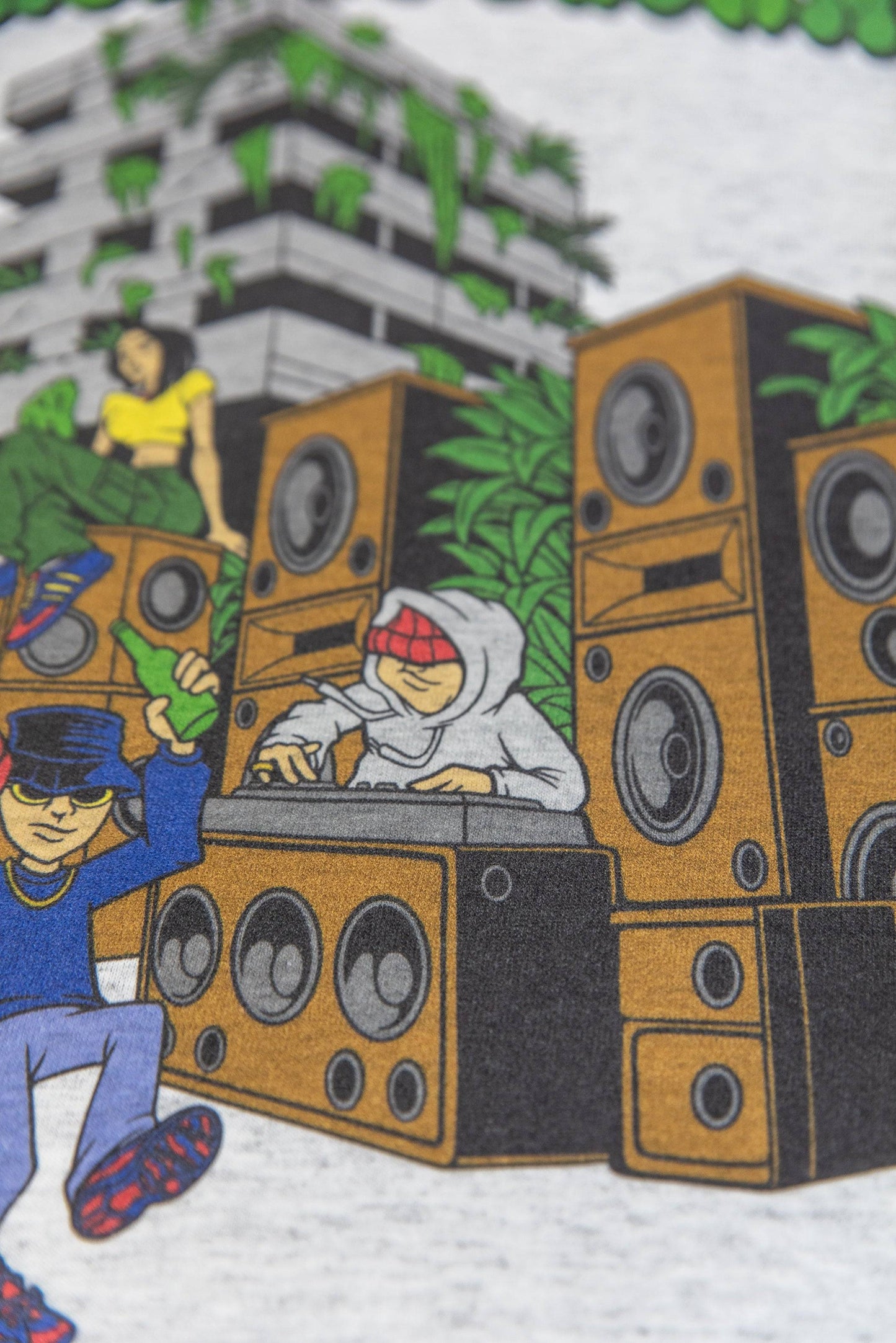 Zoomed-in view of DJ and speaker stack from Jungle Rhythms print on Ash Grey T-Shirt, highlighting bold colors and streetwear vibe.