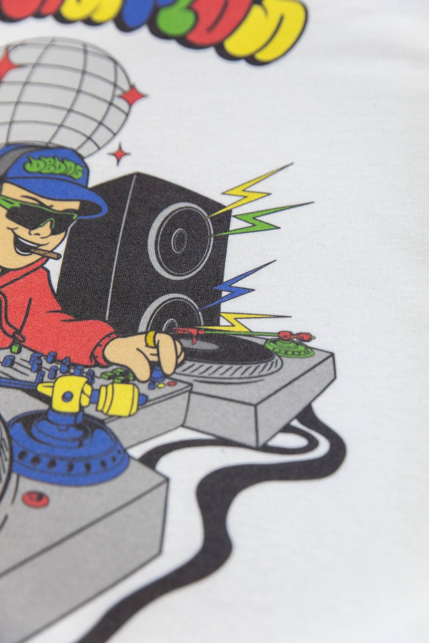 Detailed view of DJ turntable and speaker graphic on Rave Nation white T-shirt. High-quality print with lightning bolt accents.