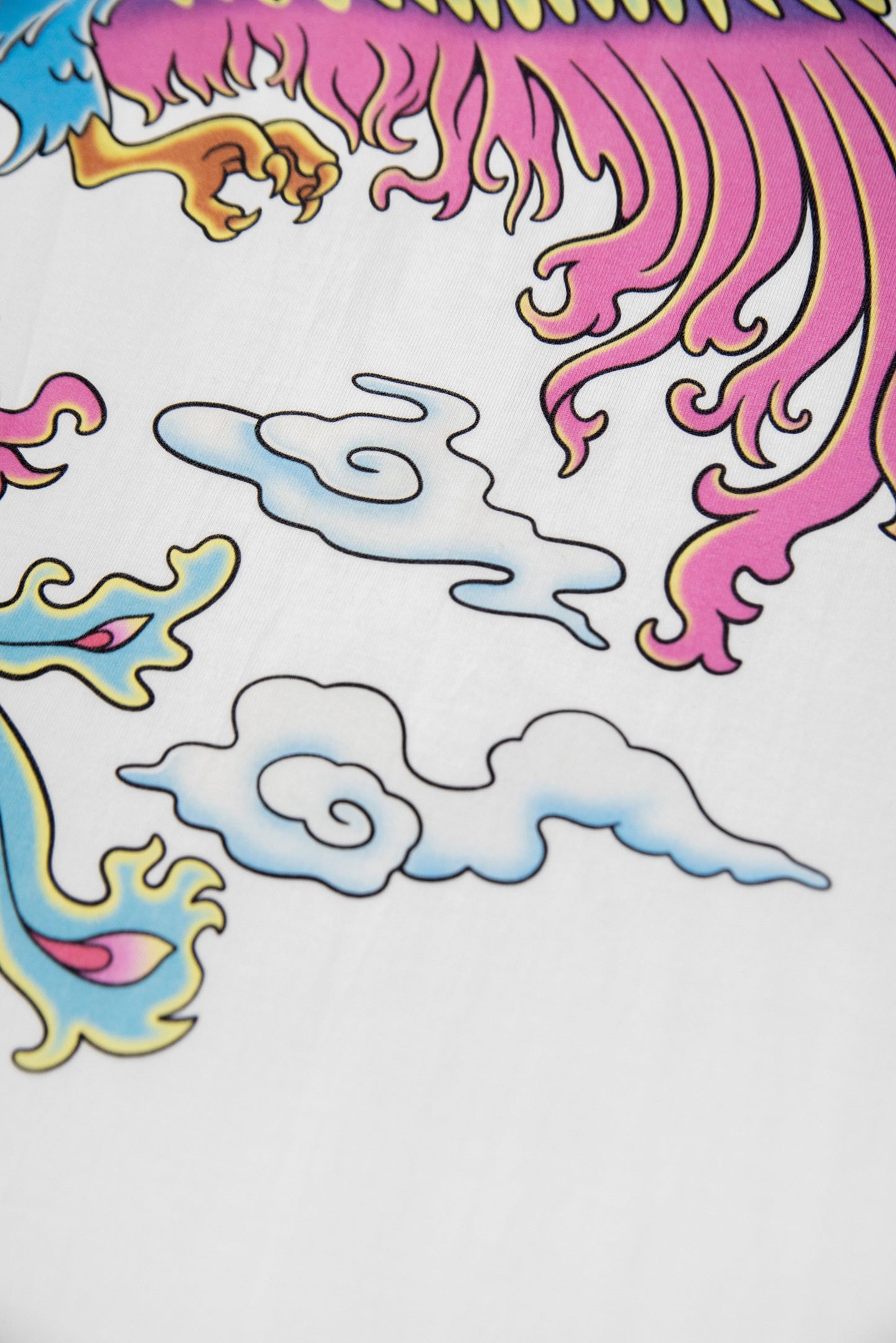 Detailed view of the White Phoenix T-Shirt's lower back print with pastel clouds and phoenix feathers. Crisp DTG design on soft cotton fabric.