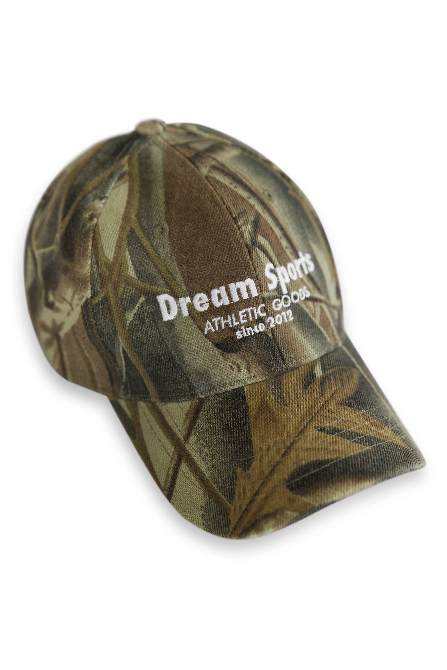 Real Tree Camo Cap with Dream Sports logo in white embroidery, featuring 6-panel design and curved brim for outdoor style and comfort.