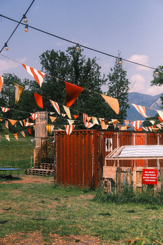 Festival area with flags and structures.
